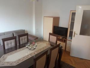 a living room with a dining table and a television at Maria's Place in Bitola