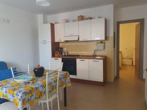 a kitchen with a table with a table cloth on it at Nancy Casa vacanze in Nizza di Sicilia