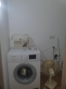 a washing machine with a box on top of it at Nancy Casa vacanze in Nizza di Sicilia