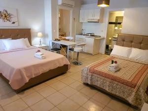 a hotel room with two beds and a kitchen at Villa Thassos Paradise in Limenas +47 photos