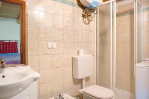 a bathroom with a toilet and a sink at Genzianella Tano di Grich in Cesani