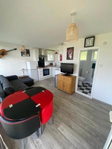 a living room with a couch and a table at Selsey Country Club Valencia Chalet in Selsey +3 photos