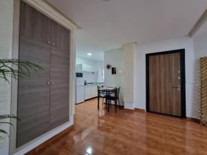 a living room with a wooden door and a table at Superb studio in Rabat in Rabat
