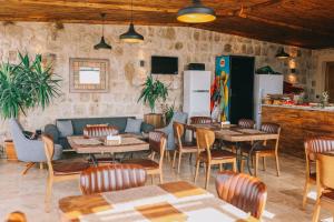 a restaurant with tables and chairs in a room at Cappadocia Vita Cave Hotel in Ürgüp