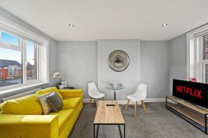 a living room with a yellow couch and a table at Lovely Flat in Maidstone - Sleeps 3 in Kent