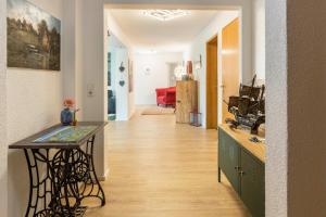 a kitchen with a table and a hallway at Haus Auryn in Markelfingen