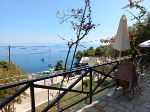 a balcony with a view of the ocean at Stafylos Rooms in Stafylos