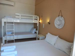 a bedroom with a bed and a bunk bed at Stafylos Rooms in Stafylos