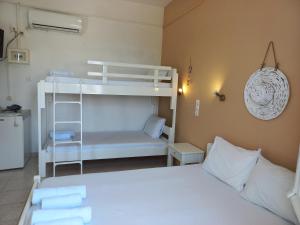 a bedroom with a bed and a bunk bed at Stafylos Rooms in Stafylos