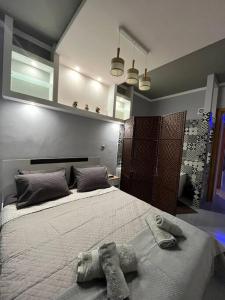 a bedroom with a large bed with towels on it at VIP Apt. Pezodromos Kalamarias in Thessaloniki
