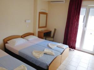 a bedroom with a bed with a bow on it at Vila Europe R in Paralia Katerinis