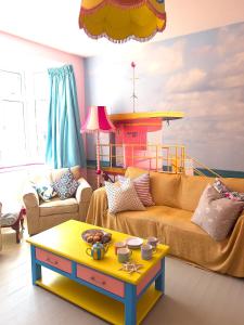 a living room with a couch and a table at Aqua Cottage in Combe Martin