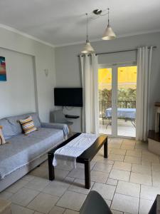 a living room with a couch and a table at Santa Emelia in Vasiliki