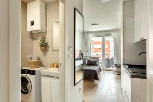 a kitchen and living room with a washer and dryer at Apartman Elena in Split