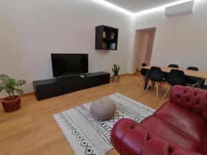 sala de estar con sofá rojo y mesa en Appartamento I Mori, en Cassibile
