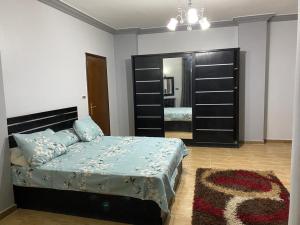 a bedroom with a bed and a large mirror at Amwaj Compound in Hurghada