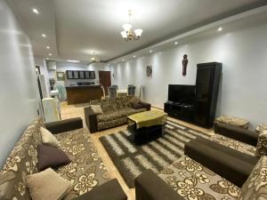 a large living room with couches and a television at Amwaj Compound in Hurghada
