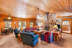 a living room with couches and a stone fireplace at The Breck House in Breckenridge