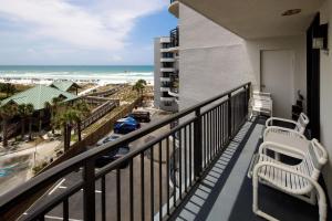 a balcony with two chairs and a view of the ocean at Nautilus 2510 Gulf View 2 Bedroom 5th Floor Free Beach Service in Fort Walton Beach