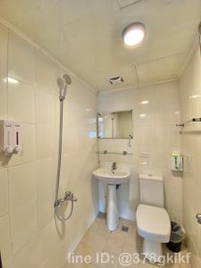 a bathroom with a sink and a toilet and a shower at 無印旅行 in Taichung