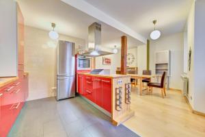 a kitchen with red cabinets and a dining table at Apartamento la Laurel by Clabao in Logroño