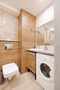 a bathroom with a washing machine and a sink at MYFREEDOM Апартаменти метро Оболонь in Kyiv