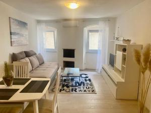 a living room with a couch and a table at Apartman Buccari in Bakar