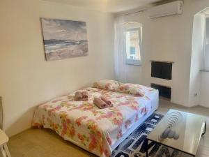 a bedroom with a bed with two bags on it at Apartman Buccari in Bakar