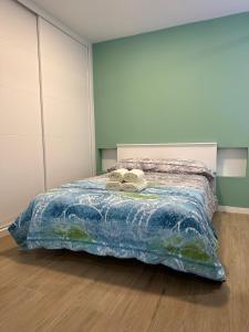 a bedroom with a bed with two shoes on it at Apartamentos Aguacate in Madrid