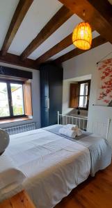 A bed or beds in a room at Gestiona2R - Casa rural Matias Mar y Montaña ideal Familias