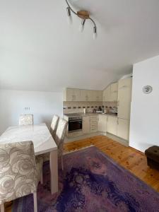 a kitchen with a table and chairs in a room at Mariner House in Plav