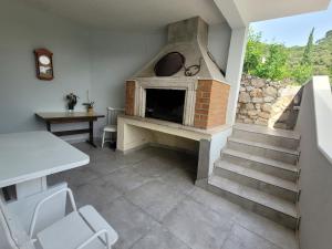 a living room with a fireplace and a staircase at Dragovoda bay in Ubli