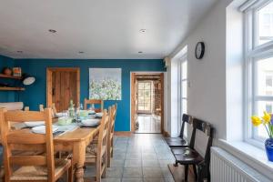 a dining room with a wooden table and chairs at Charming Chepstow Home in Chepstow