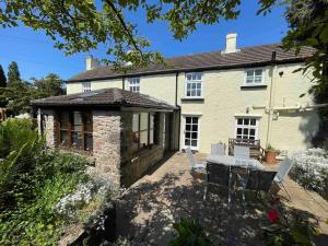 a house with a table and chairs in front of it at Charming Chepstow Home in Chepstow