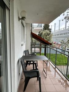 a balcony with a table and a chair on a balcony at Pension Seckbach in Frankfurt