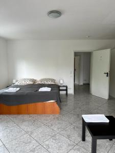 a bedroom with a bed and a room with a table at Pension Seckbach in Frankfurt/Main