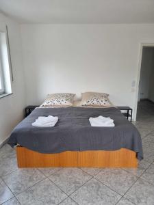 a bedroom with a bed with two towels on it at Pension Seckbach in Frankfurt/Main