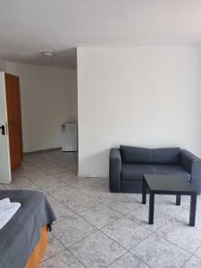 a living room with a couch and a table at Pension Seckbach in Frankfurt/Main
