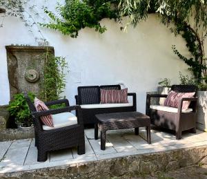 a group of wicker chairs and tables and a table at Art apartment in downtown Porto in Porto