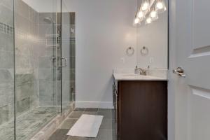 a bathroom with a shower and a sink at Luxe Townhouse Flat in Hip Neighborhood, Near Metro in Washington