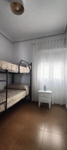 a room with two bunk beds and a table at Mi Casita del Cabo in El Cabo de Gata +6 photos