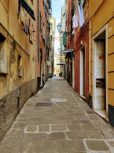 an empty street in an alley between buildings at La Peglina in Genoa