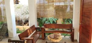 a living room with a bench and a table at Casa Yoo Bigu Mazunte in Mazunte