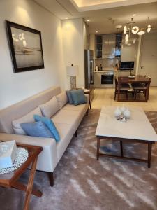 uma sala de estar com um sofá e uma mesa em Address Beach Resort Fujairah - 2 bedroom apartment em Fujairah