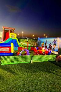 a playground with a toy train on the grass at Grand Hills North Coast in Dawwār ‘Abd Allāh