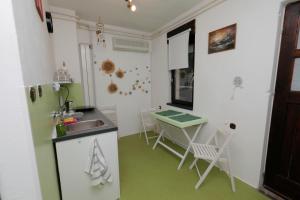 a kitchen with a sink and a table at Maple place in Velika Gorica