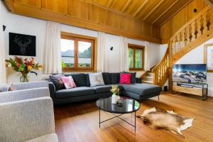 a living room with a couch and a table at Chalet Mora-lodge by Alpine Host Helpers in Kitzbühel
