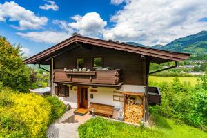 a house with a balcony on top of it at Chalet Mora-lodge by Alpine Host Helpers in Kitzbühel