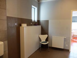 a small room with a chair and a wall at Cozy Place in Müllendorf