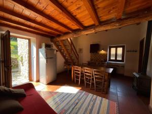 a kitchen and living room with a table and a refrigerator at Agriturismo Giandriale in Tavarone